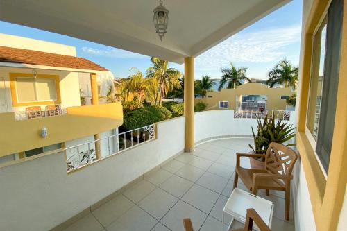 a balcony with a view of a house at Condominios JAROJE in Santa Cruz Huatulco