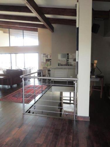 a metal staircase in a room with a living room at Whalesong Villa in Hermanus