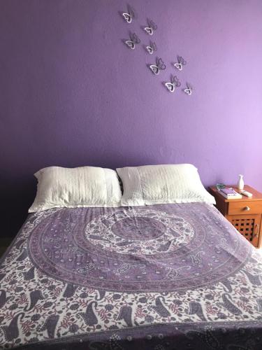 um quarto roxo com uma cama com uma parede roxa em Habitación Potter em Cancún