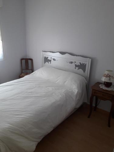 - une chambre dotée d'un lit blanc avec une tête de lit et une table dans l'établissement RCh Parking 2 Ch Commerces Plage, à Berck-sur-Mer