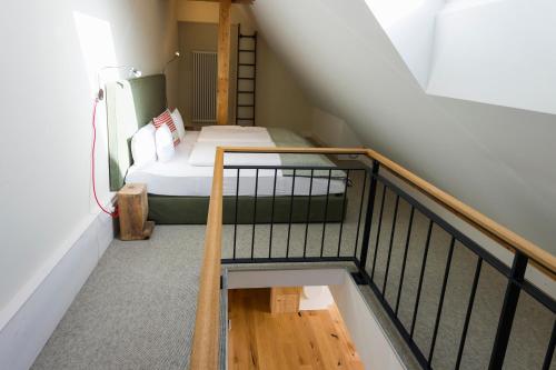 a small room with a bed and a staircase at Berghaus Freiburg - Appartement Hotel auf dem Schauinsland in Oberried