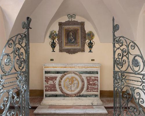 a room with a fireplace with a picture on the wall at San Domenico Palace, Taormina, A Four Seasons Hotel in Taormina