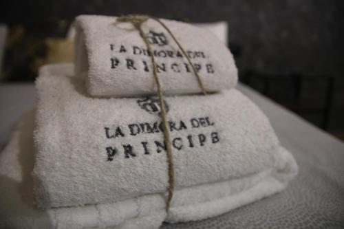 a stack of towels with writing on them at La Dimora del Principe-Piano terra in Trani