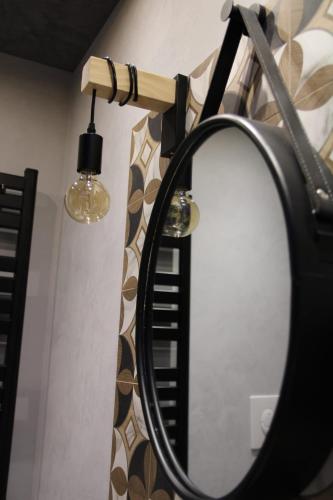 a mirror hanging on a wall with a microphone at La Dimora del Principe-Piano terra in Trani