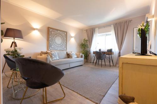 a living room with a couch and a table at BEACHOME4U3 in Carcavelos