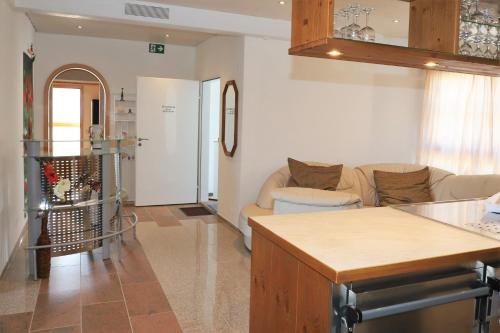 a kitchen and a living room with a couch at Gästehaus Willaringen in Rickenbach