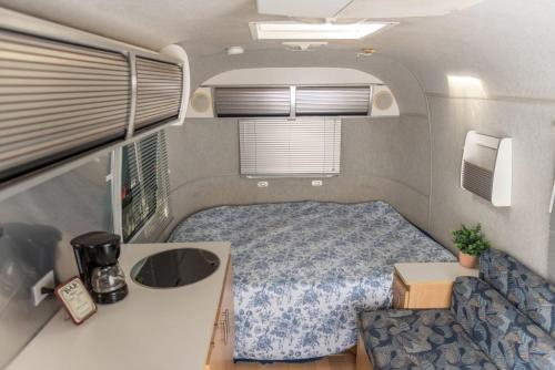 a small bedroom in a tiny house at Airstream in the Center of it All in Miami