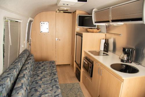 an rv kitchen with a sink and a counter at Airstream in the Center of it All in Miami