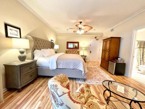 a bedroom with a bed and a table and chairs at Inn on Main Hotel in Manasquan