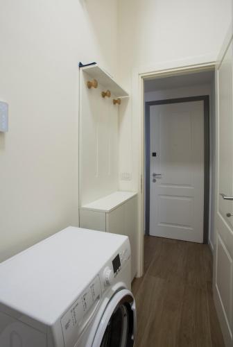 a laundry room with a washer and dryer in it at La Casa di Nausicaa - Vespero in Reggio Calabria