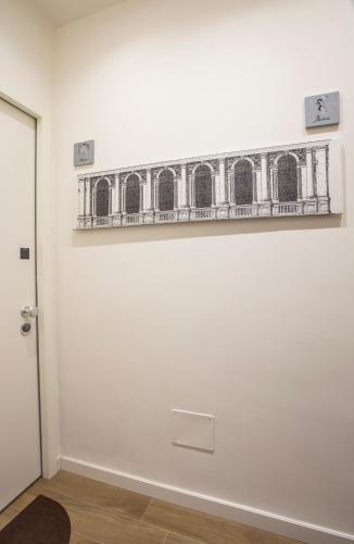 a painting of a train on a white wall at La Casa di Nausicaa - Vespero in Reggio Calabria
