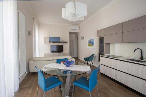 a kitchen and living room with a table and chairs at La Casa di Nausicaa - Vespero in Reggio Calabria