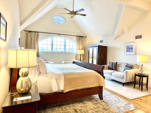 a large bedroom with a bed and a couch at Inn on Main Hotel in Manasquan