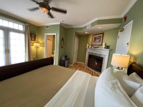 a bedroom with a bed and a fireplace at Inn on Main Hotel in Manasquan