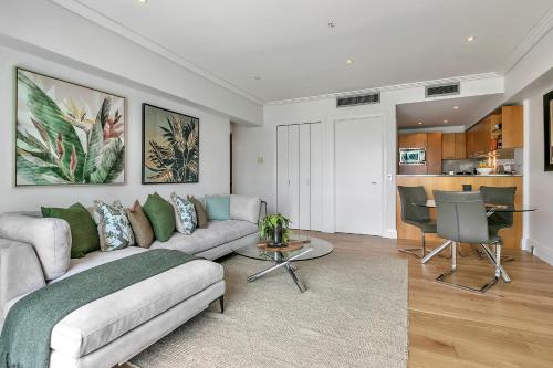 a living room with a couch and a table at Ultimate outdoor-living Urban Getaway! 1 Carpark in Auckland