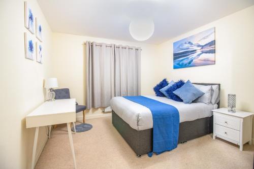 a bedroom with a bed and a desk in it at Virexxa Bletchley - Executive Suite - 2Bed Flat with Free Parking in Milton Keynes