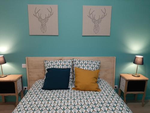 a bedroom with a bed with two tables and two lamps at LOUHANS Les Petites Arcades avec ses deux appartements coté Arcades et coté cour in Louhans
