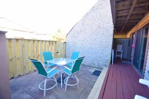 a patio with a table and chairs on a deck at Club Ocean Villas II 182 condo in Ocean City