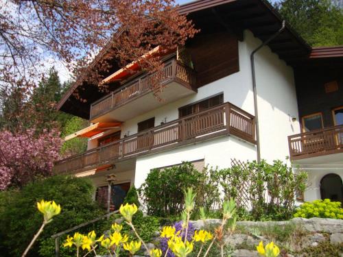 a building with balconies and flowers in front of it at Haus Margrit Ferienwohnung in Sonnenlage in Golling an der Salzach