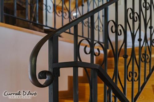 a black wrought iron stair railing with a staircase at Curral D Avó Turismo Rural & SPA in Caçarelhos