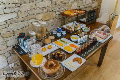 a table full of breakfast foods and drinks at Curral D Avó Turismo Rural & SPA in Caçarelhos