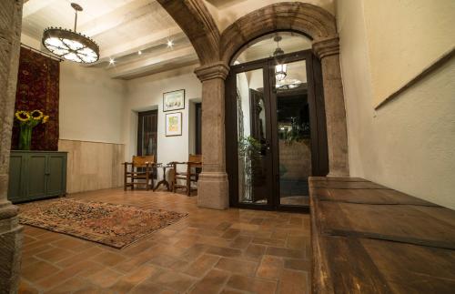 a large hallway with an entry way with an archway and a room with at Villa Mirasol in San Miguel de Allende