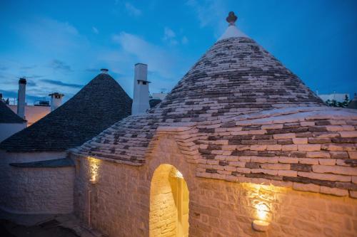 a building with a roof with lights on it at La Mandorla Luxury Trullo in Alberobello