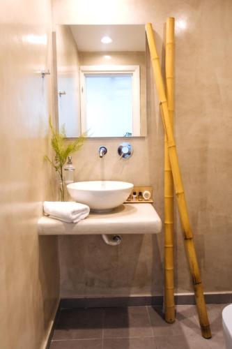 a bathroom with a sink and a mirror at Amer Villa Santorini with outdoor hot tub in Vóthon