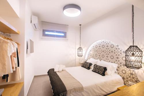 a bedroom with a bed with an ornate headboard at Amer Villa Santorini with outdoor hot tub in Vóthon