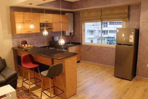 a kitchen with a counter and a refrigerator in a room at Luxury Appartement Noor in Fès