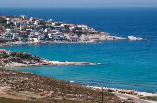 a town on a hill next to the ocean at Ikaros Star Hotel in Gialiskari