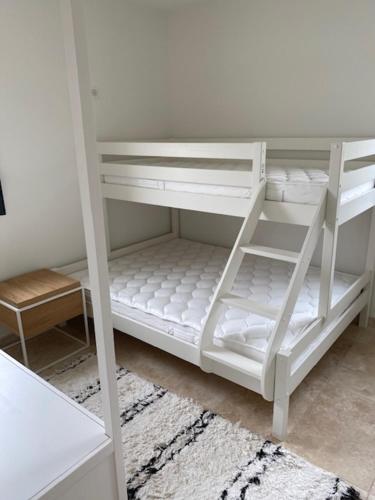 a white bunk bed with white shelves in a room at Les Palivettes 2.1 in Malaucène