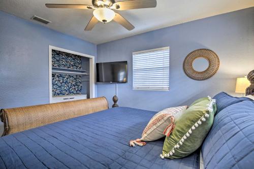 a woman laying on a bed in a bedroom at Tropical Palm Harbor Retreat with Lanai and Patio! in Palm Harbor