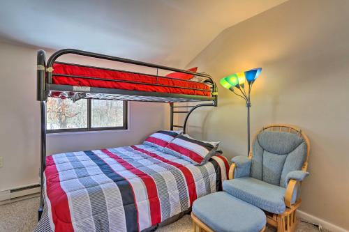 a bedroom with a bunk bed and a chair at Pet-Friendly Poconos Getaway with Resort Perks! in Lackawaxen