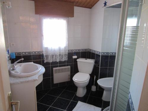 a small bathroom with a toilet and a sink at Maison LES SABLES D'OLONNE 700 m Plage WIFI in La Pironnière