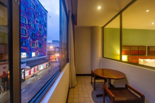 a room with a table and a window at Balmoral Hotel San José CR, Historic District in San José