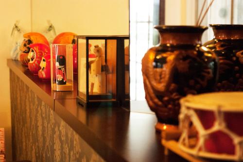 a shelf with vases on top of a counter at Hara Palace Hotel in Curitiba