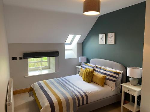 a bedroom with a bed and a window at Beehive Barn in Berwick-Upon-Tweed