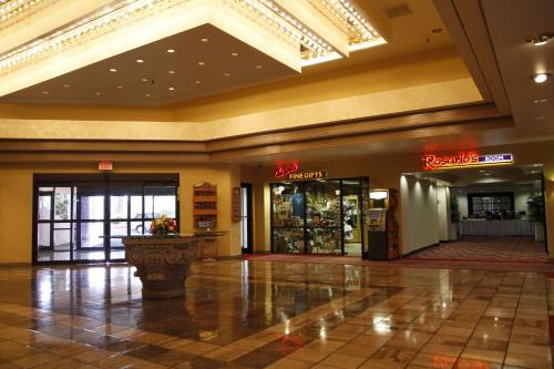 a lobby of a shopping center with a store at Ramada by Wyndham Viscount Suites Tucson East in Tucson