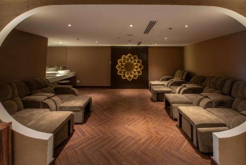 a waiting room with a row of chairs and a table at Wyndham Garden Hanoi in Hanoi