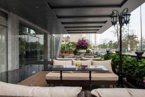 a restaurant with a table and chairs on a balcony at Wyndham Garden Hanoi in Hanoi