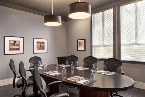 a meeting room with a table and chairs at Royal Hotel Regina, Trademark Collection by Wyndham in Regina