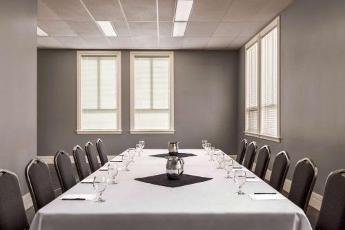 a conference room with a long table and chairs at Royal Hotel Regina, Trademark Collection by Wyndham in Regina