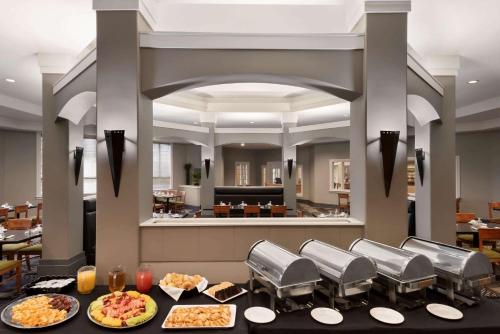 a buffet line with plates of food in a restaurant at Royal Hotel Regina, Trademark Collection by Wyndham in Regina