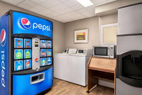 a pepsi machine in a room with a desk at Royal Hotel Regina, Trademark Collection by Wyndham in Regina
