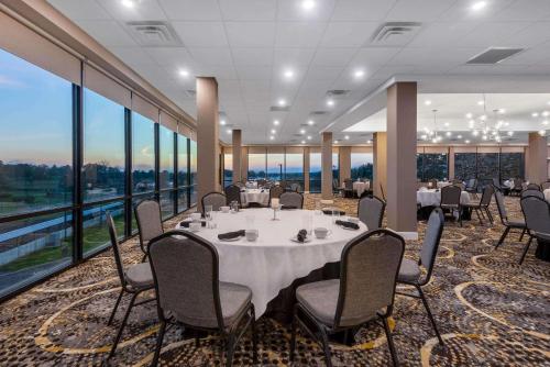 a conference room with a table and chairs and windows at Wyndham Lancaster Resort and Convention Center in Lancaster