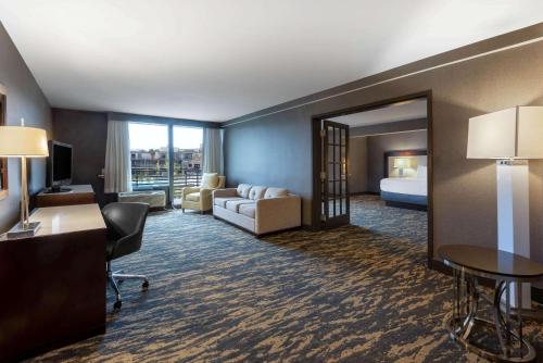 a hotel room with a bed and a desk at Wyndham Lancaster Resort and Convention Center in Lancaster