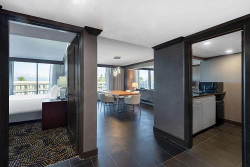 a hotel room with a bed and a kitchen and a table at Wyndham Lancaster Resort and Convention Center in Lancaster