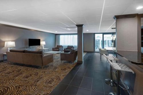 a lobby with couches and a television in a building at Wyndham Lancaster Resort and Convention Center in Lancaster