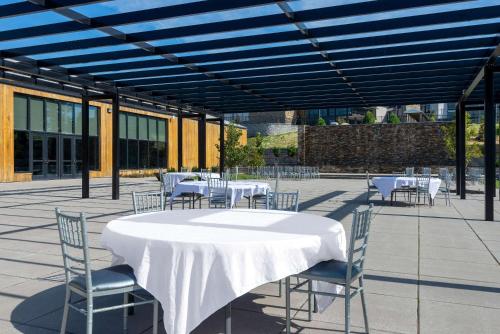 a table and chairs with a white table and chairsktop at Wyndham Lancaster Resort and Convention Center in Lancaster